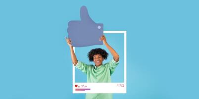 A cheerful individual holds a large thumbs up symbol, demonstrating approval and engagement. The background is bright blue, creating a lively atmosphere perfect for social media content. photo