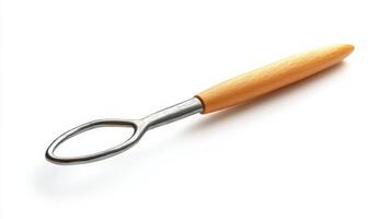A medical instrument with a wooden handle. photo