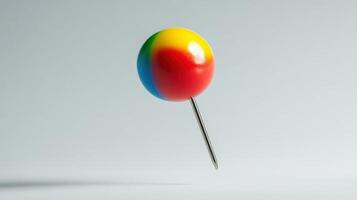 Colorful pushpin floating against a neutral background. photo