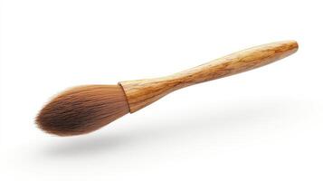 A light brown wooden-handled paintbrush with a fluffy head. photo