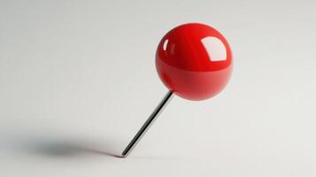 Glossy, red pushpin on a light background. photo