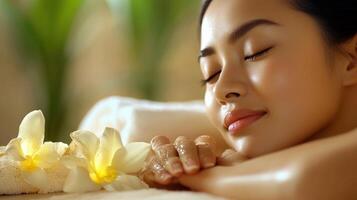 A woman laying on a massage table with flowers photo