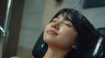 Relaxed young woman enjoying a gentle shower. photo