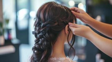Complex braided hairstyle being styled by a professional. photo