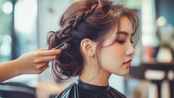 Elegant braided updo being styled in a salon. photo