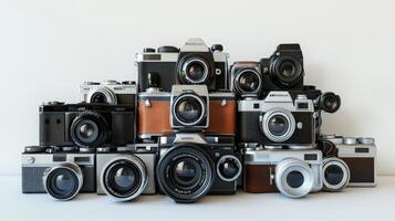 Collection of vintage cameras displayed in a stack. photo