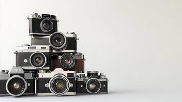 Stacked vintage cameras against a plain background. photo