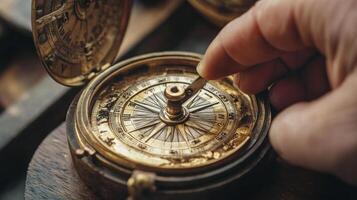 Antique compass being adjusted by a hand. photo