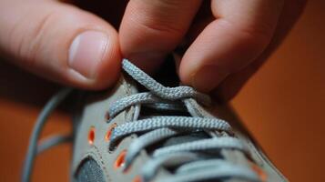 Close-up view of hands tying shoe laces. photo