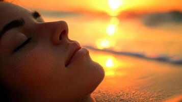 Close-up view of a peaceful woman resting by the golden sunset beach. photo