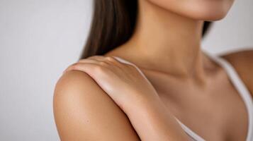 Closeup view of a person's shoulder and hand. photo