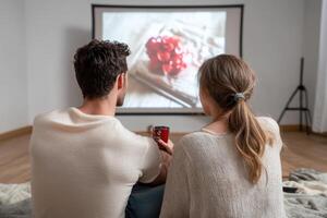 Couple Watching Movie at Home with Drinks photo