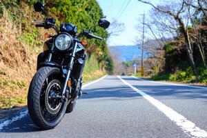 Black Motorcycle on a Scenic Country Road in Spring photo