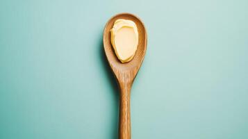 A Single Scoop of Butter in a Wooden Spoon Simple Food Photography photo