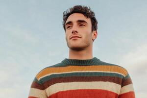 Stylish Man in a Striped Sweater, Capturing Autumn Vibes photo