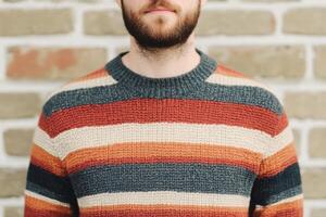 Man in a Cozy Knitted Striped Sweater photo