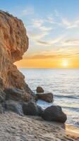 Spectacular sunset over the ocean, with golden light illuminating the rocky beach and cliff. A serene and peaceful seascape, perfect for relaxation and travel inspiration. photo