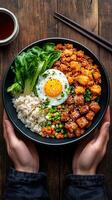 A Vibrant and Flavorful Asian Inspired Bowl with Rice, Crispy Pork, Egg, and Vegetables photo