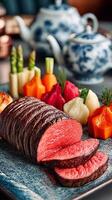 A Culinary Masterpiece Sliced Roast Beef with Exquisite Sides and Elegant Tea Set photo