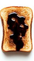 A of a Perfectly Toasted Slice of Bread with a Dark Drizzle of Sauce, Perfect for a Simple Breakfast photo