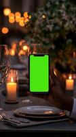 Elegant Restaurant Dinner Scene with Smartphone Display Capture the Warmth and Ambiance of a Luxurious Dining Experience photo