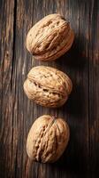 Three Walnuts on Rustic Wooden Table A Nutritious and Delicious Treat photo