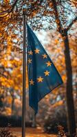 European Union Flag Waving Majestically in Autumn Park A Symbol of Unity and History photo