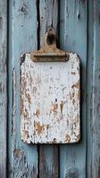 Old wooden clipboard on a blue painted wall photo