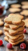 A stack of cookies with raspberries on top photo