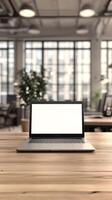 Laptop on wooden table in office with blank screen photo