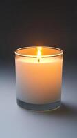 Illuminating Ambiance A Serene Burning Candle in Glass. Perfect for creating a cozy, relaxing atmosphere at home. Find peace and tranquility with this warm, gentle glow. photo