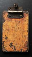 Vintage Leather Clipboard Aged Texture, Grunge Background, Retro Office Stationery. Perfect for adding a touch of antique charm to your projects. A worn, distressed, and timeworn design element. photo