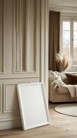 A white frame sitting on the floor next to a couch photo