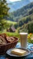A delightful countryside breakfast Fresh bread, creamy butter, and a glass of milk, all enjoyed with a breathtaking mountain view. The perfect start to a relaxing day in nature. photo