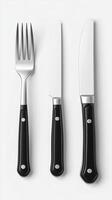 Sleek and Modern Cutlery Set A Stylish Addition to Your Table Setting. This image showcases a minimalist design with black handles photo