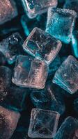 view of glistening ice cubes, showcasing their intricate textures and cool, cyan hues. The macro photography reveals the beauty of photo
