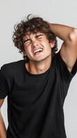 Portrait of a Young Man Experiencing Intense Frustration and Stress. The image captures a moment of emotional distress, showcasing photo