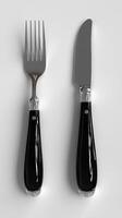 Black Handled Silver Cutlery Elegant Dinnerware Setting for Modern Dining. High gloss finish and minimalist design. Perfect for f photo