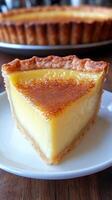 A delectable slice of golden custard tart, a heavenly dessert with a creamy texture and a hint of cinnamon. This baked pastry is t photo