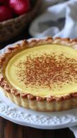 A delectable custard tart, its golden crust encasing a creamy, cinnamon dusted filling. A symphony of flavors and textures, this d photo