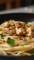of a delectable dish spaghetti with succulent chicken pieces, seasoned with aromatic garlic and herbs. Each strand of pasta is coa photo