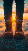 A breathtaking sunset view from the mountain top. Adventurous journey, boots on the rocky ground, enjoying the golden hour. A pers photo