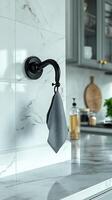 Sleek Black Metal Towel Hook in Modern Kitchen Setting A Perfect Blend of Style and Functionality. This high end design element ad photo