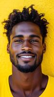 A Captivating Portrait of a Smiling Black Man with a Stylish Beard and Hair, Set Against a Vibrant Yellow Background. The Image Ev photo
