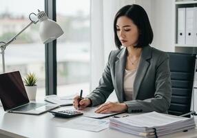 A woman in a business suit is writing on a piece of paper photo