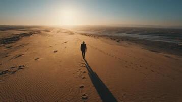 Sunset Desert Landscape A Solitary Figure Walks Towards the Golden Horizon. A breathtaking view of footprints in the sand, capturi photo
