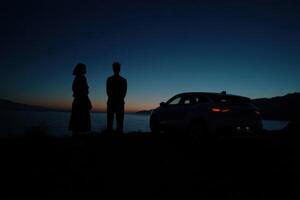 Romantic Couple Silhouette at Sunset by the Ocean, Enjoying a Scenic Road Trip. The Perfect Getaway for Two, Filled with Tranquili photo