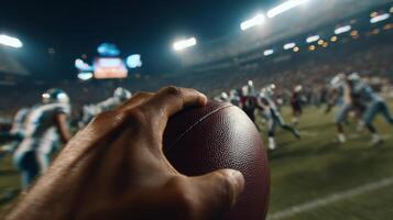 Gridiron Glory A of an American Football Game at Night. The Hand Holds the Ball, the Stadium Lights Shine Brightly, and the Energ photo