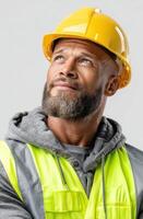 Portrait of a Construction Worker A Thoughtful Gaze Towards the Future. A image of a man in a hard hat and safety vest, looking photo
