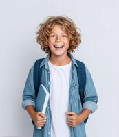 Portrait of a Happy Schoolboy with Backpack and Book. Smiling Child Ready for School, Education Concept. Joyful and Excited Studen photo